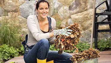 Woman picking up leavs.